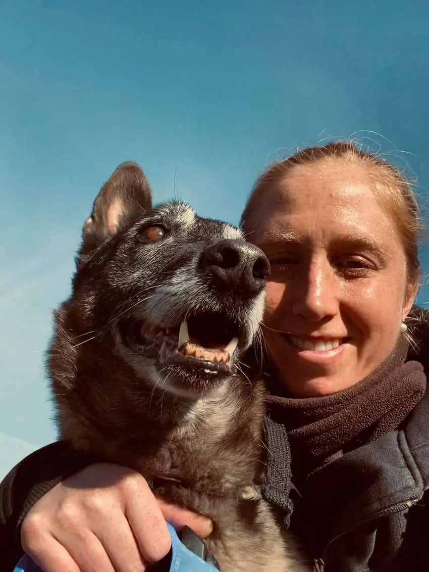 Janina Wange an Wange mit ihrem Hund in der Sonne